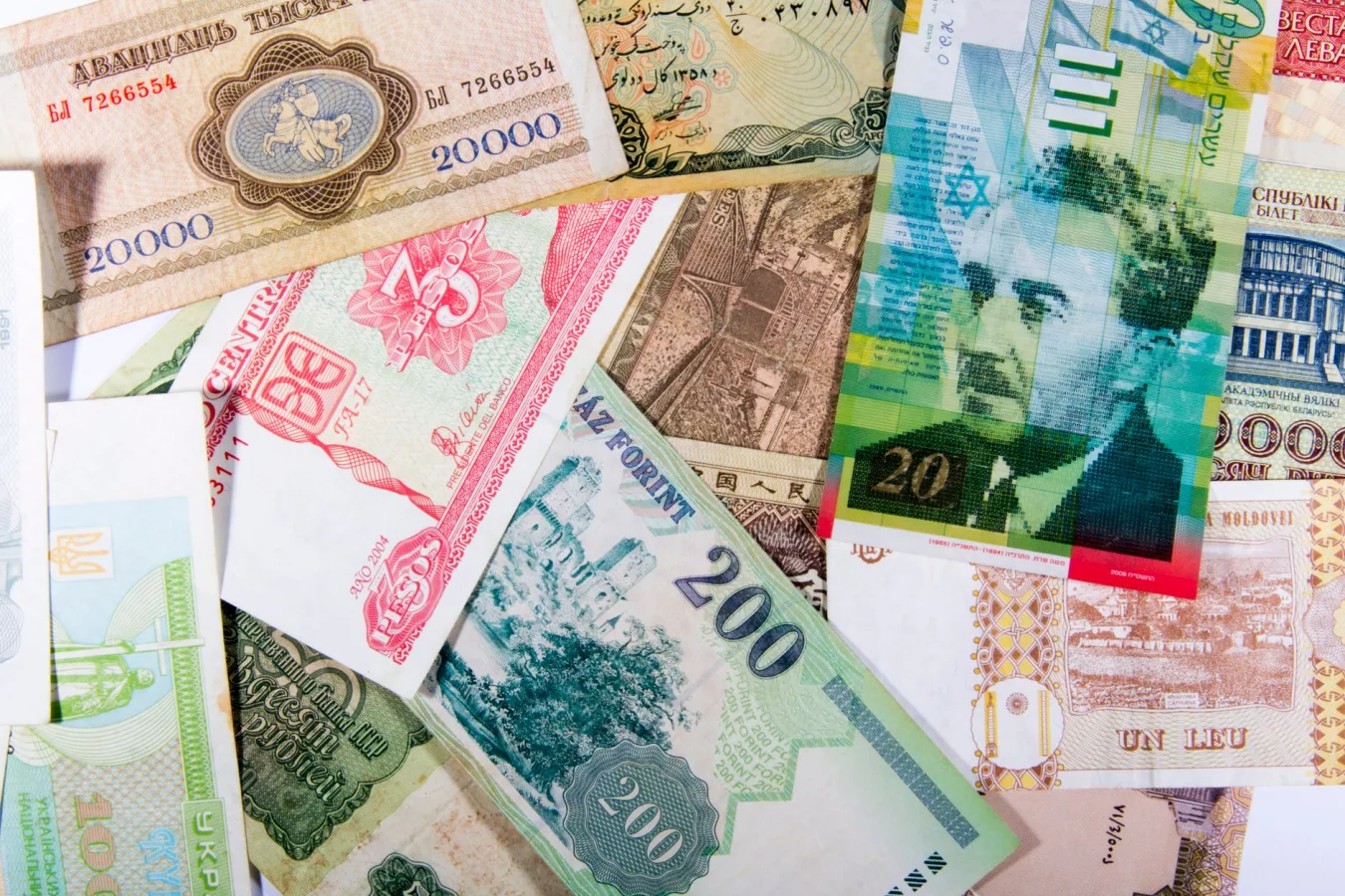 Colorful assortment of international paper currencies from various countries in a flat lay
