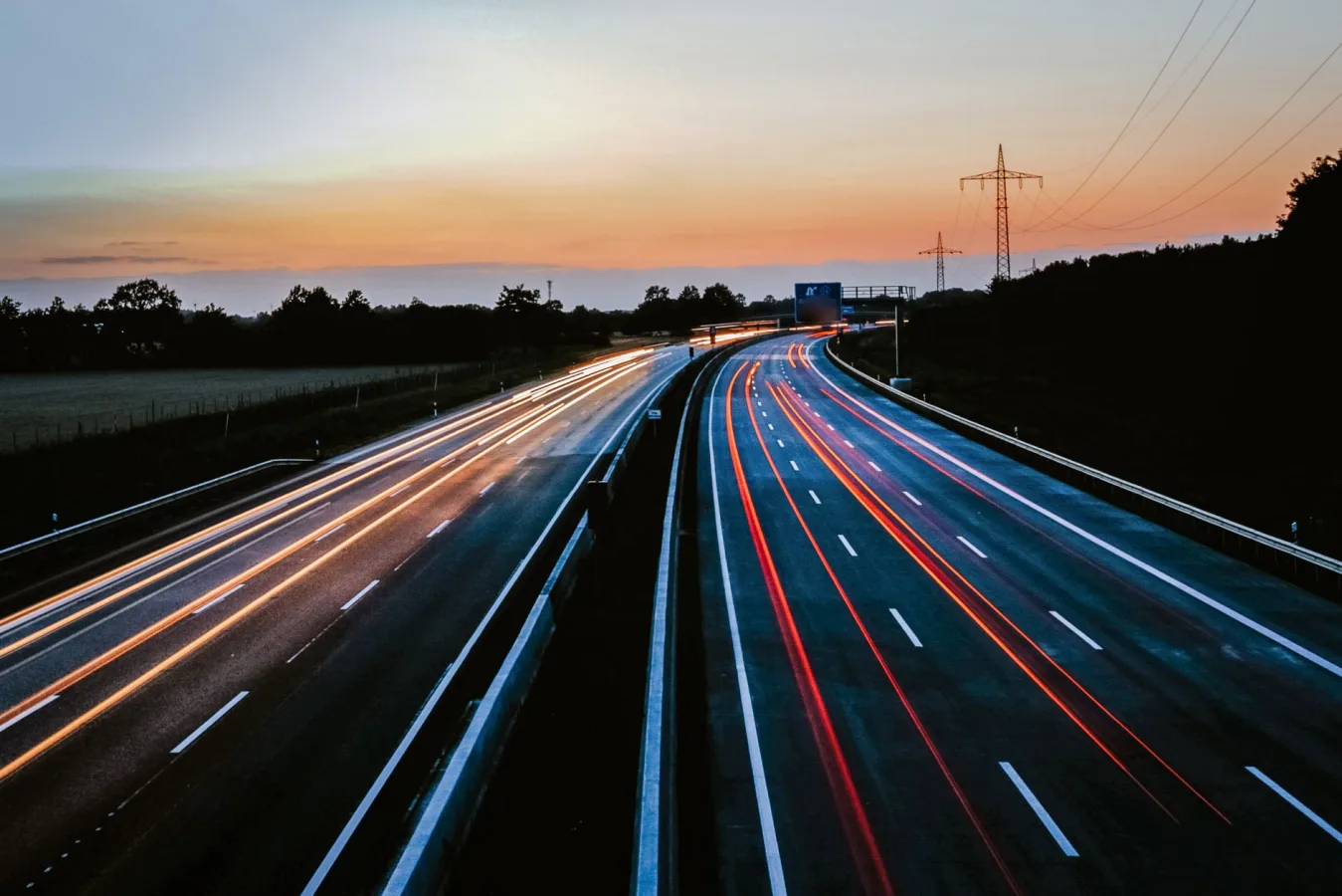 Stunning long exposure of light trails on a highway during dusk, showcasing movement and s