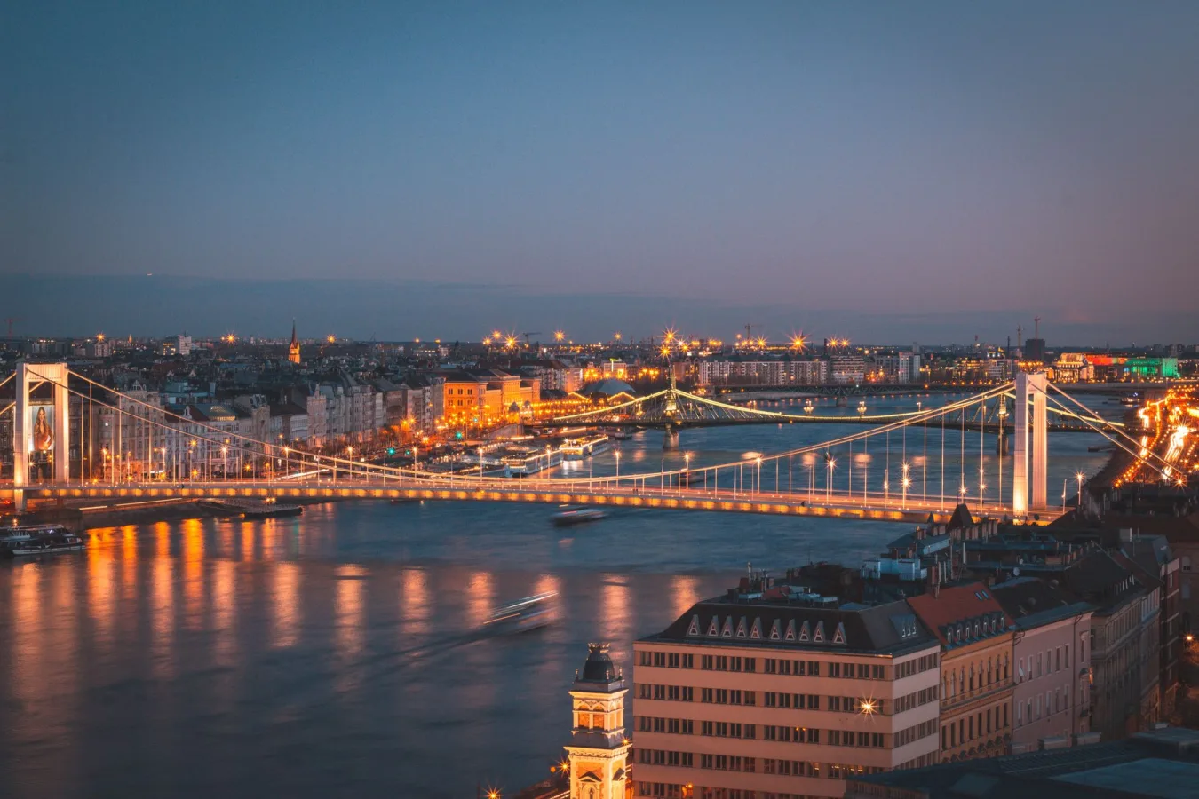 Stunning aerial view of the illuminated Elisabeth Bridge over the Danube River at night in